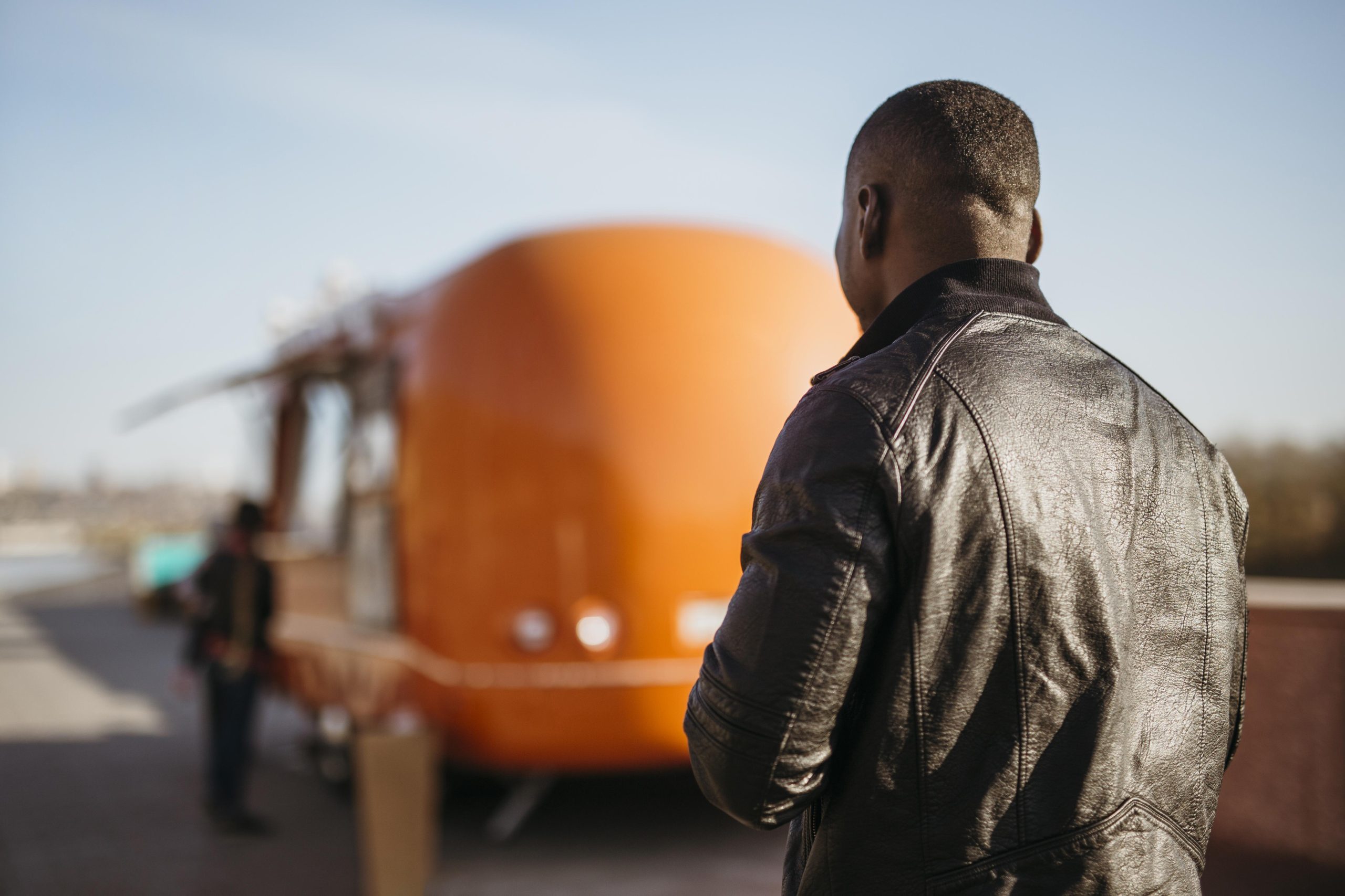 mid-shot-man-walking-towards-food-truck