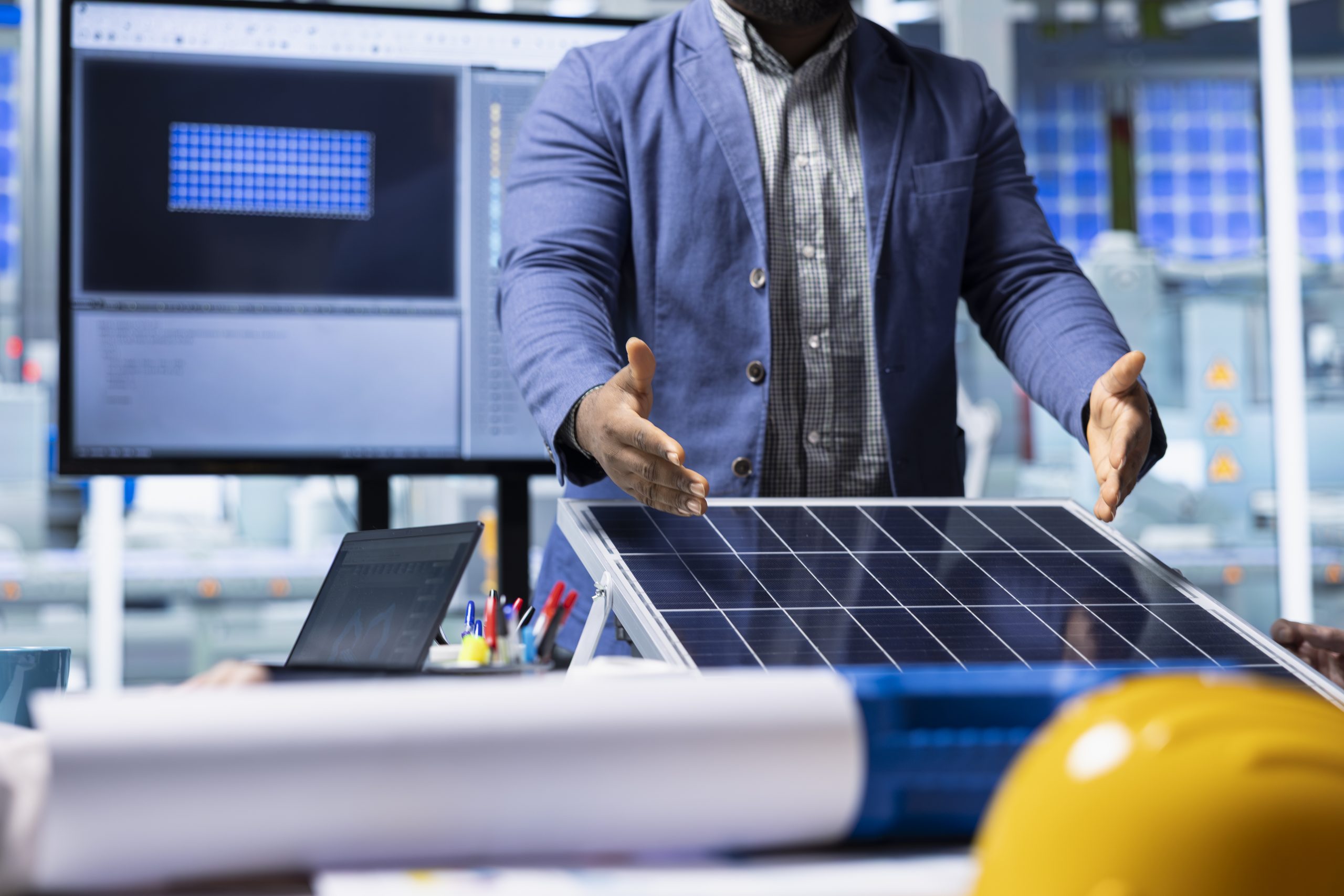 Photovoltaics factory team evaluating solar cells designs to improve efficiency. Solar panels plant businessmen in office analyzing PV materials to study how to harness sun power