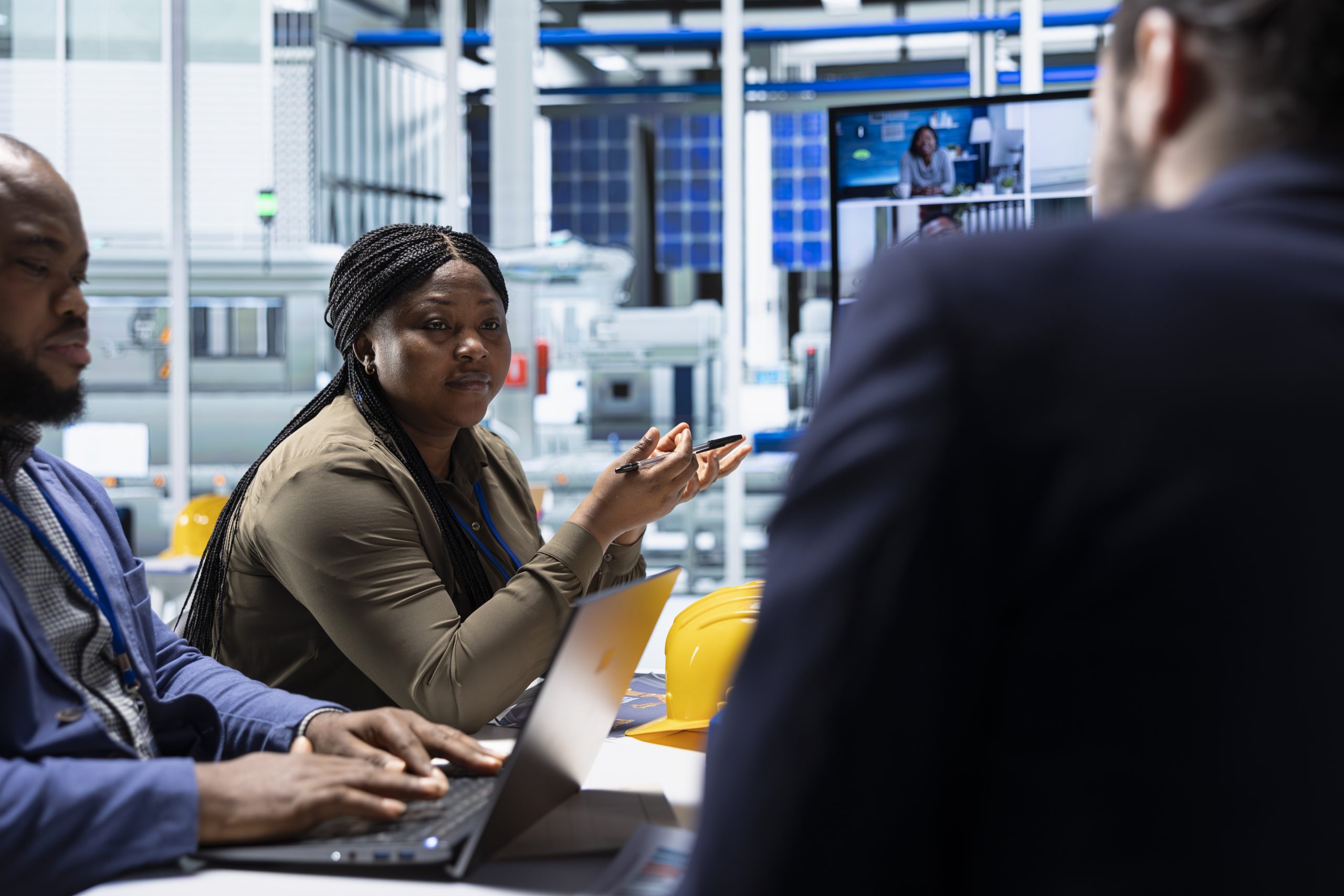Solar panels plant employees in teleconference meeting research solar solutions with notebook. Photovoltaics factory engineers using laptop to improve solar panels efficiency during internet videocall